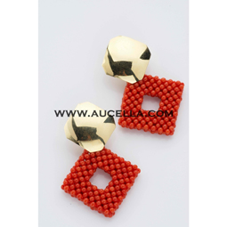 Earrings set in gold with red coral beads